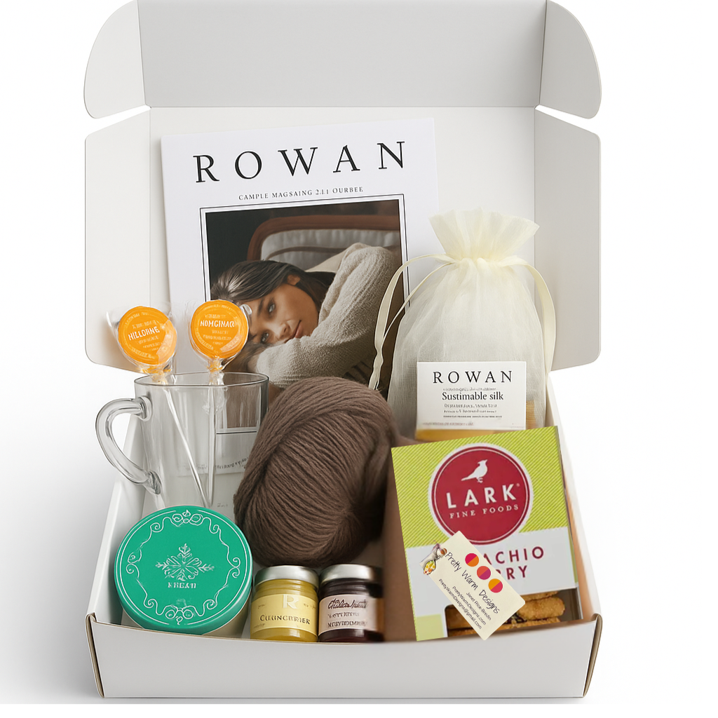 Gift box with Rowan yarn, a mug, and other items on a white background